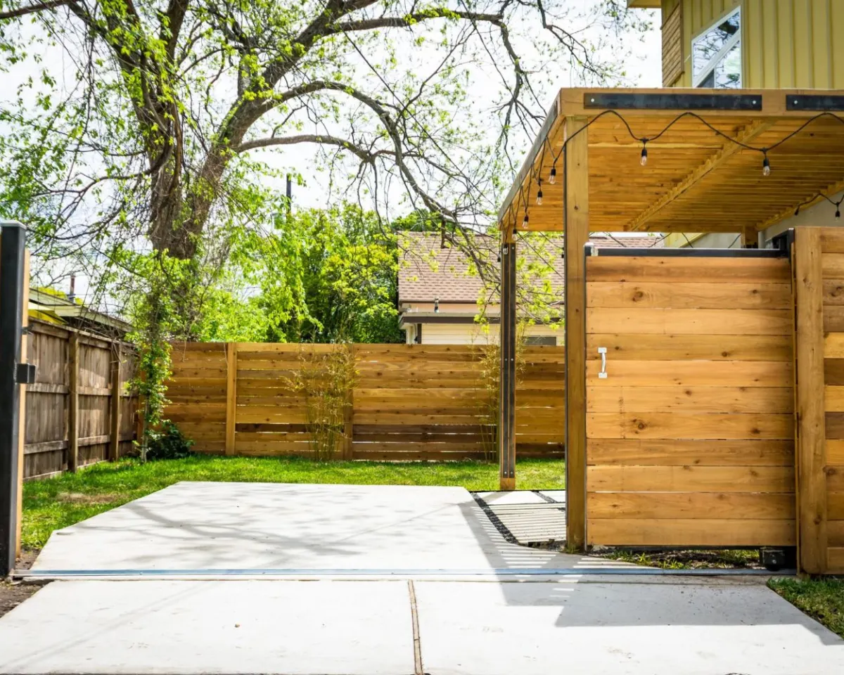 New horizontal cedar privacy fence and gate beside a driveway