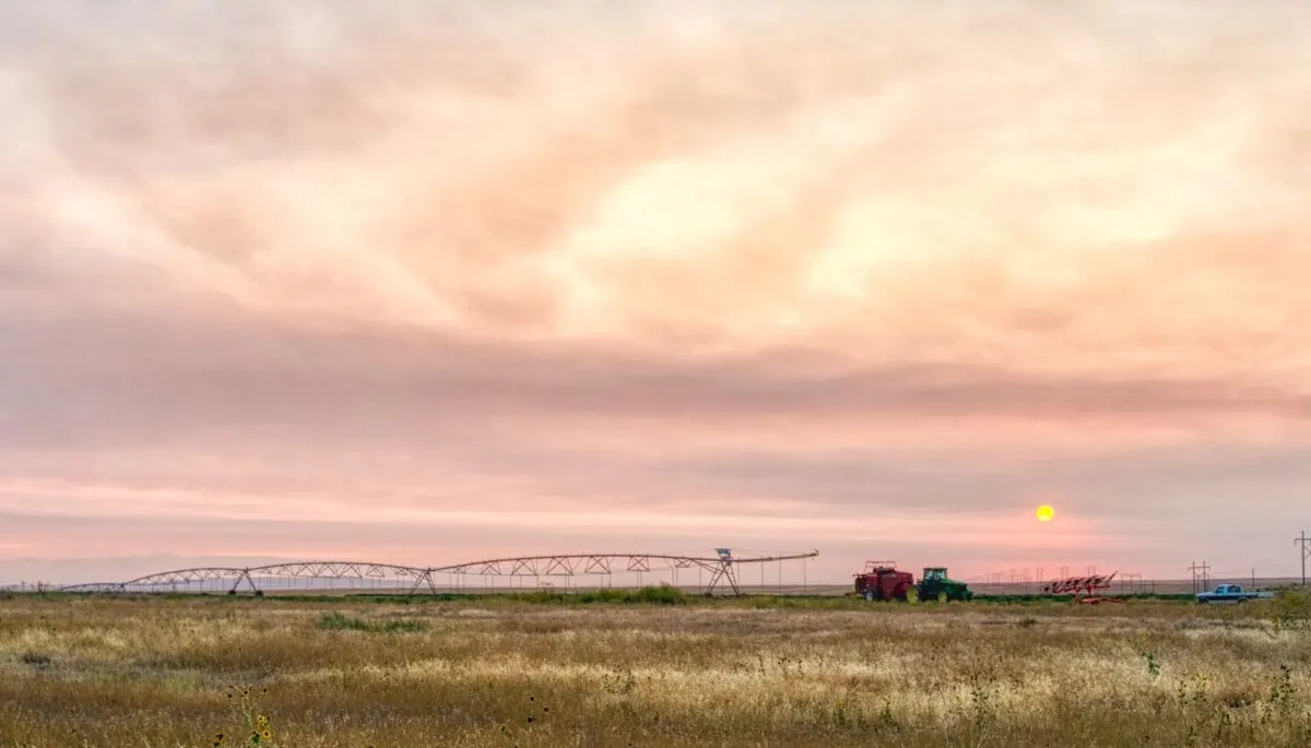 Irrigated farmland with a center pivot at sunset in southern Idaho